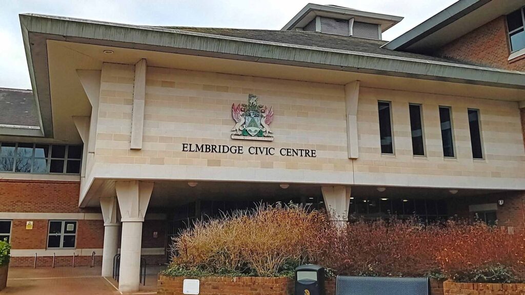 Elmbridge Borough Council building with text overlay: Have Your Say on the Future of Local Government in Surrey